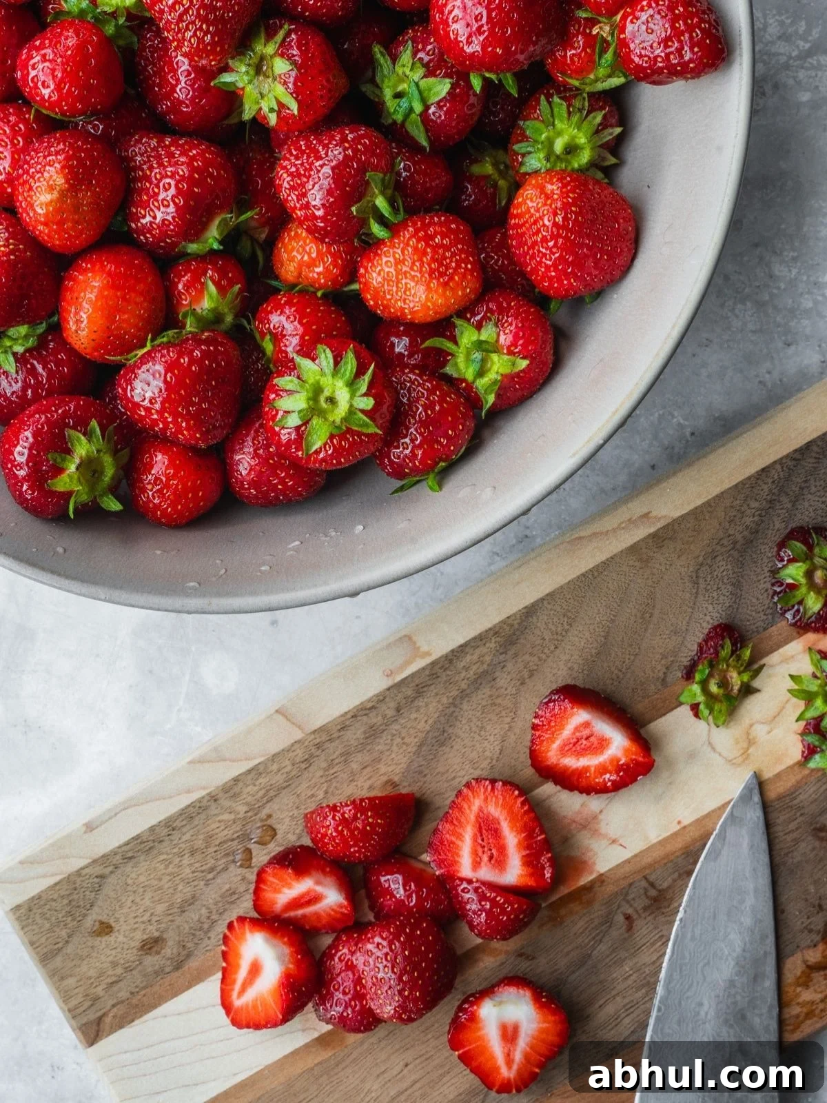 Strawberry-Balsamic Jam with Black Pepper — Homemade Recipe 4 Cutting strawberries on a wooden cutting board.