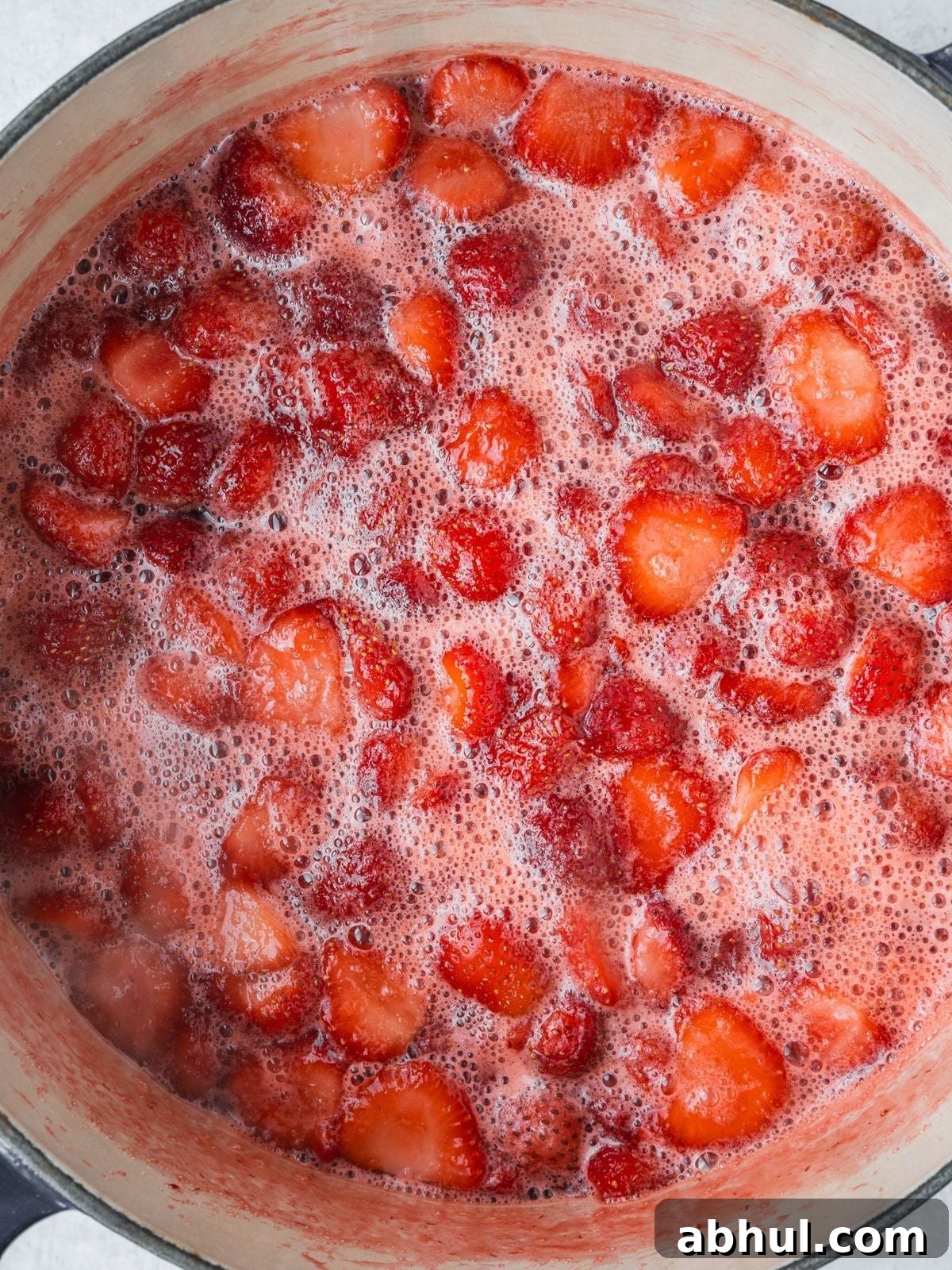Strawberry-Balsamic Jam with Black Pepper — Homemade Recipe 7 Pot of bubbling strawberries with foam coming to the top.