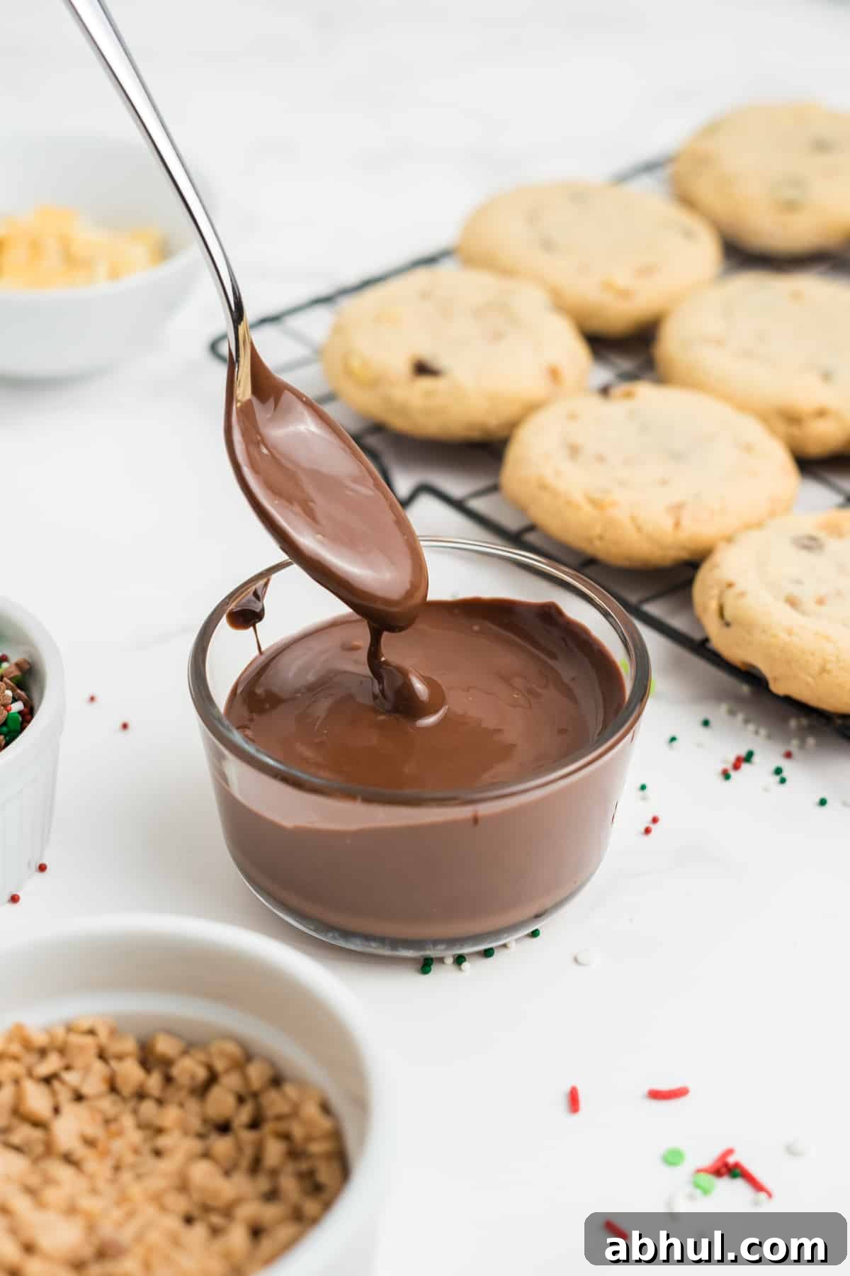 Christmas Crack Cookies Recipe: Salty-Sweet Holiday Crackers 11 Melted chocolate in a small glass bowl.