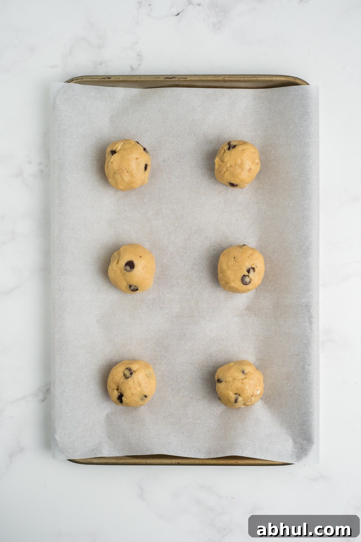 Christmas Crack Cookies Recipe: Salty-Sweet Holiday Crackers 9 Raw cookie dough balls on a baking sheet.