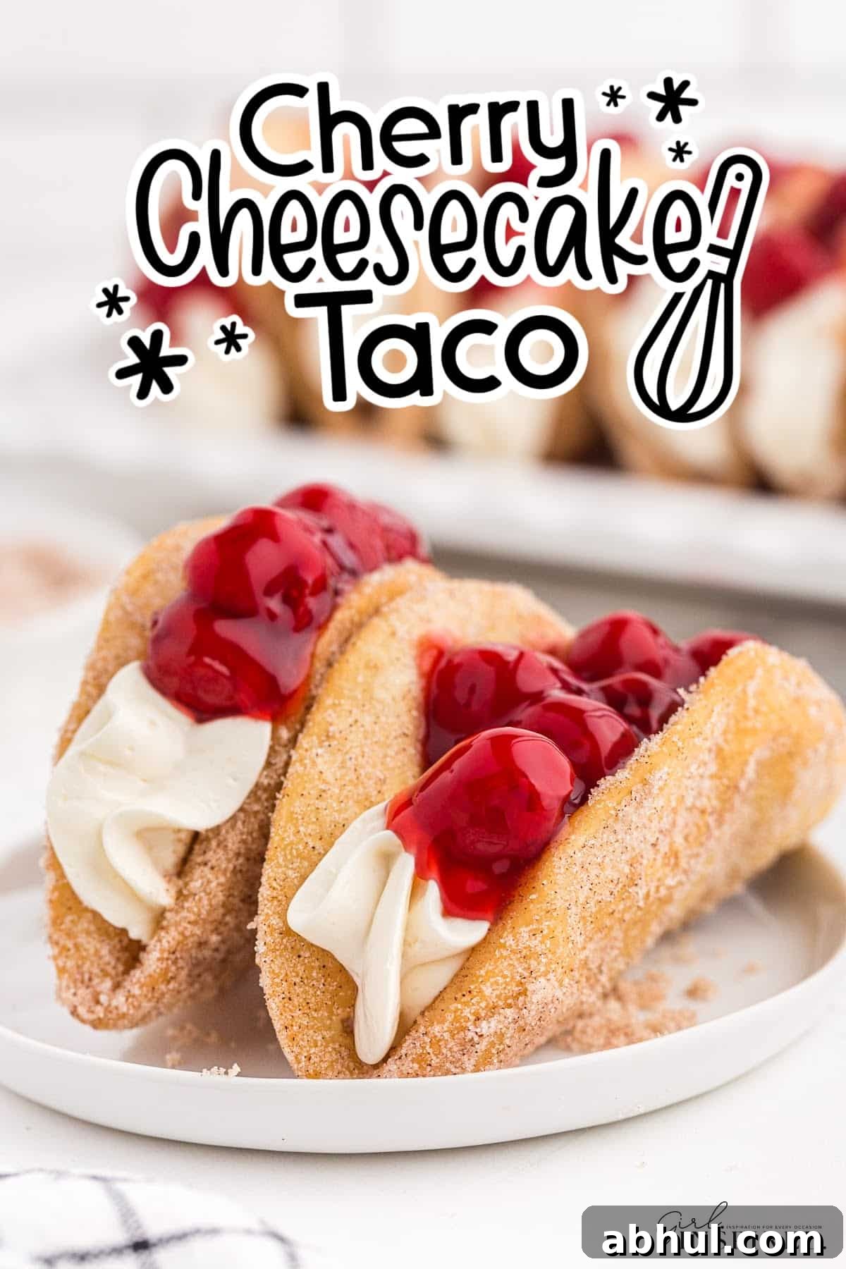 Two Cherry Cheesecake Tacos on a plate with text overlay.