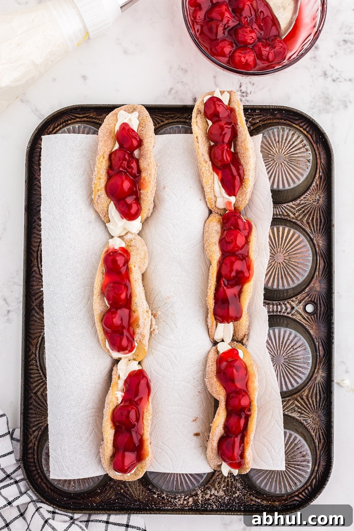 Topping the tacos with the cherry filling.