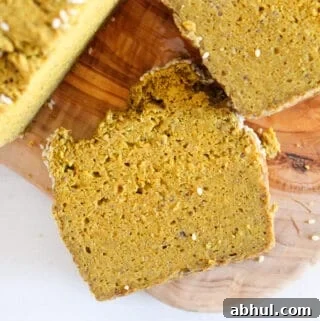 slice of chia seed bread on a cutting board.