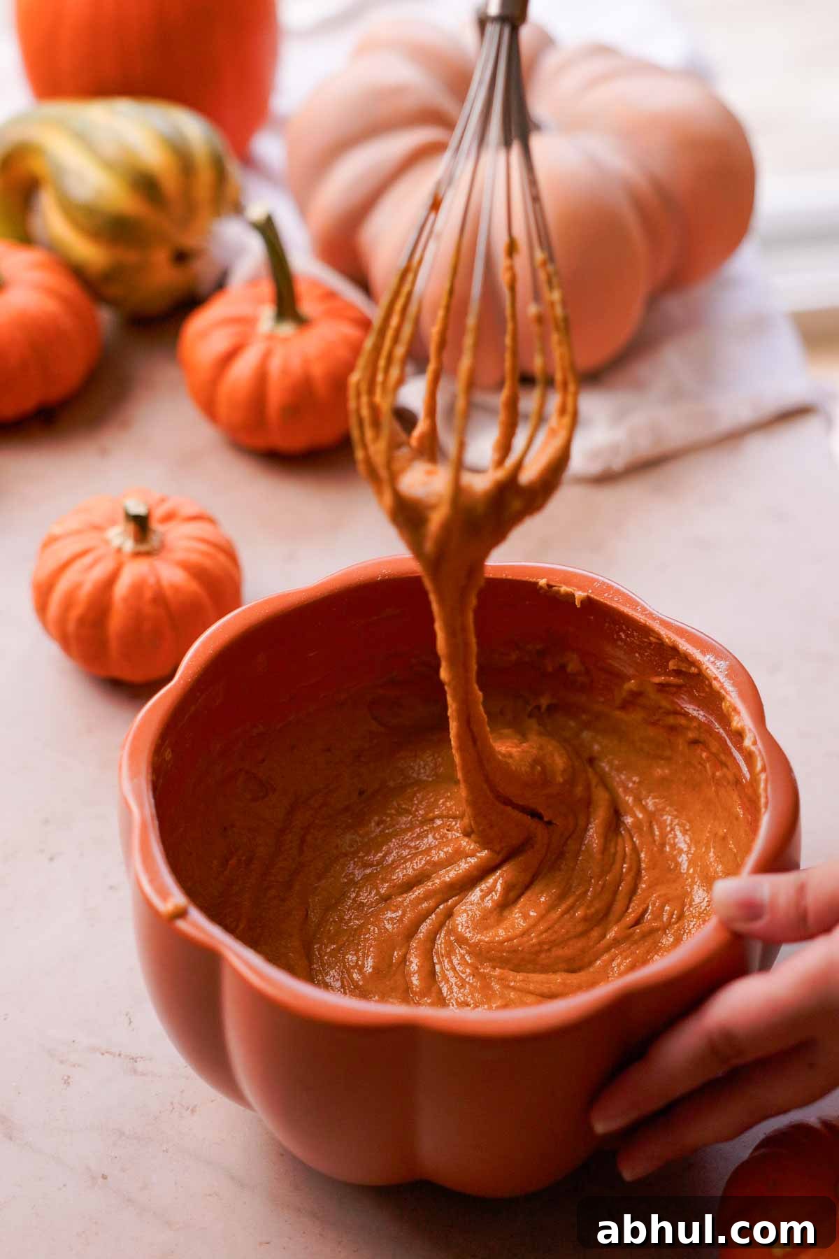 pumpkin bread batter falling off a whisk