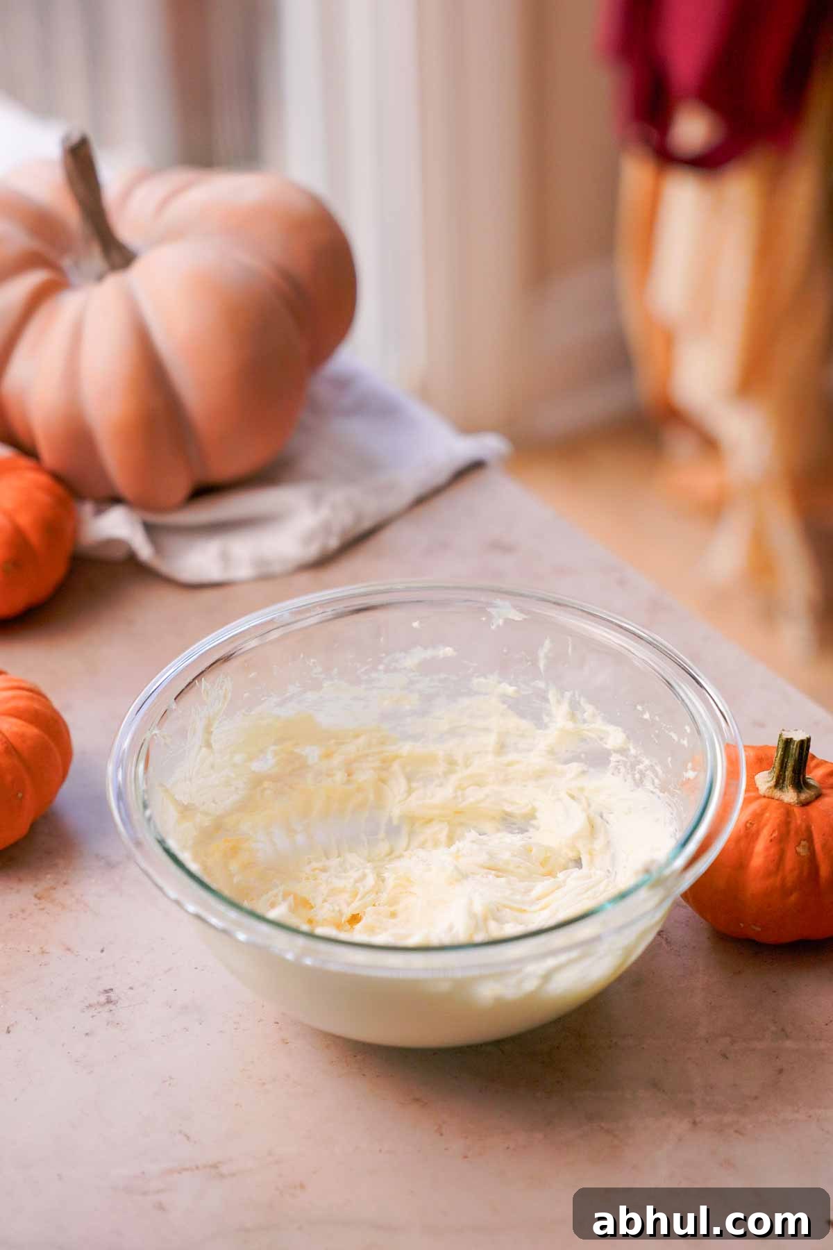 cream cheese and sugar mixed in glass bowl