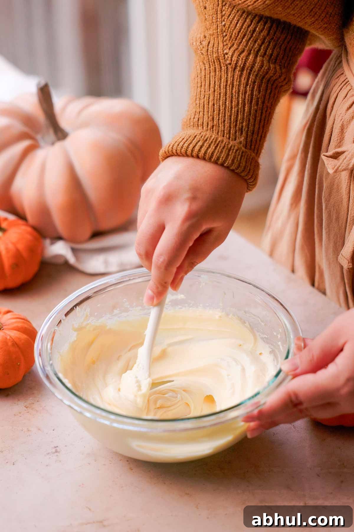 stirring cream cheese batter with spoon