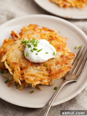 gluten free potato pancakes (Kartoffelpuffer in Austria) topped with some sour cream and chives