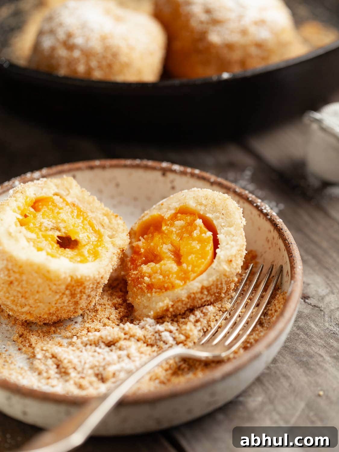 Split open Gluten Free Marillenknödel (Austrian Apricot Dumplings) in a plate