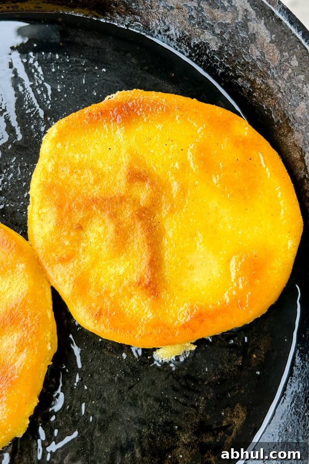 fresh arepas frying in oil