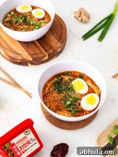 Spicy Gochujang Chicken Ramen Recipe for Quick Weeknights 13 Two bowls of gochujang chicken ramen are on a white counter.