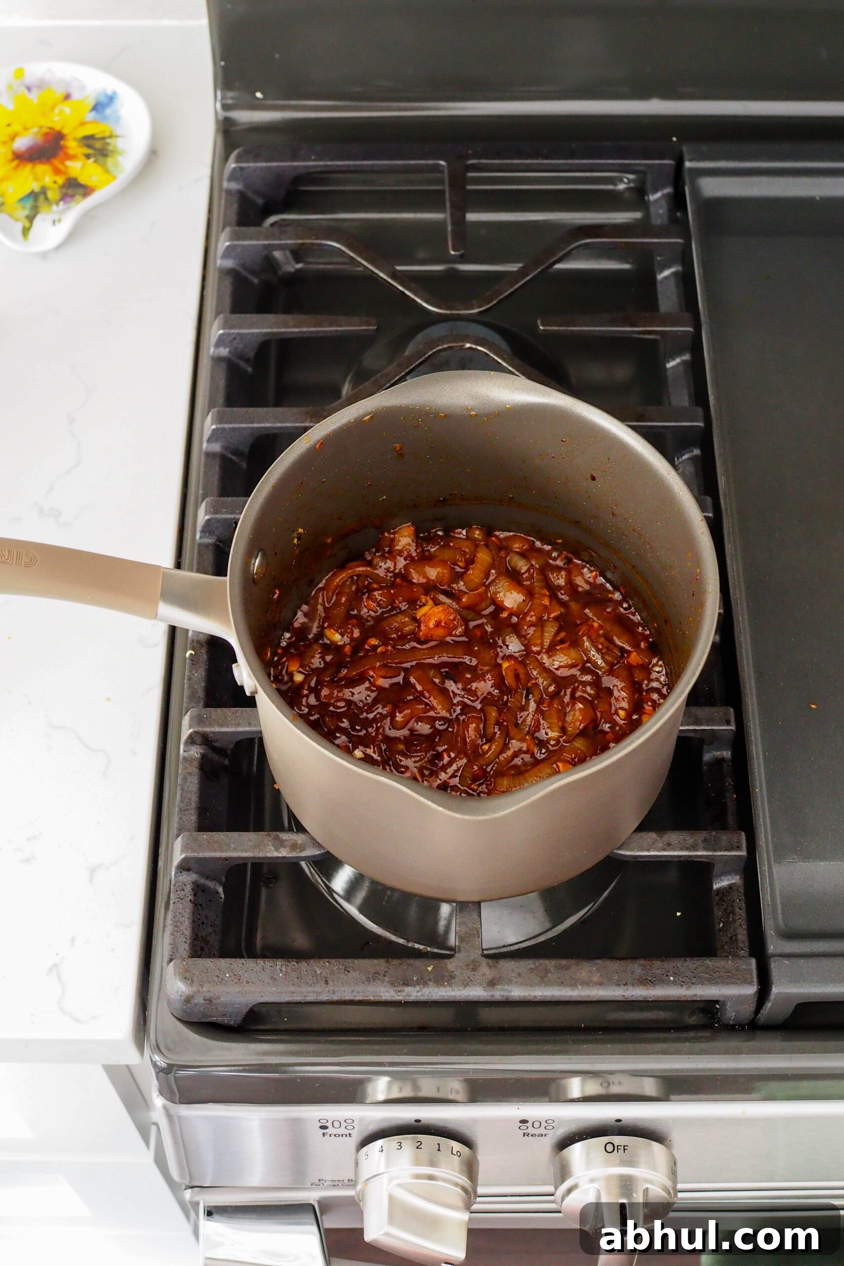 Spicy Gochujang Chicken Ramen Recipe for Quick Weeknights 9 A pot of sticky caramelized onions, gochujang, and soy sauce.
