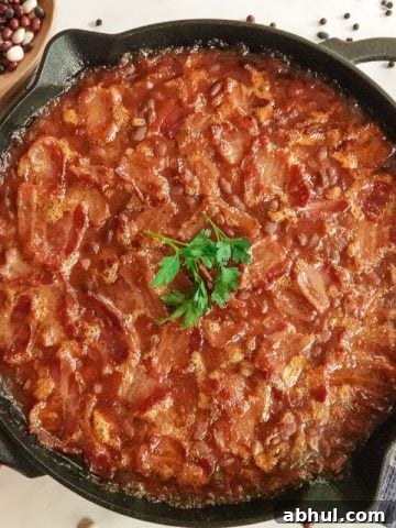 Baked beans in cast iron pan with hand towel