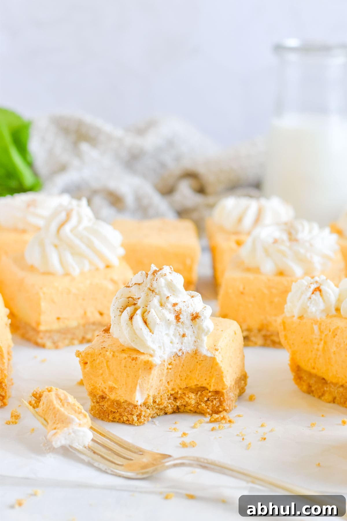 cheesecake square with bite out of it and fork on side.