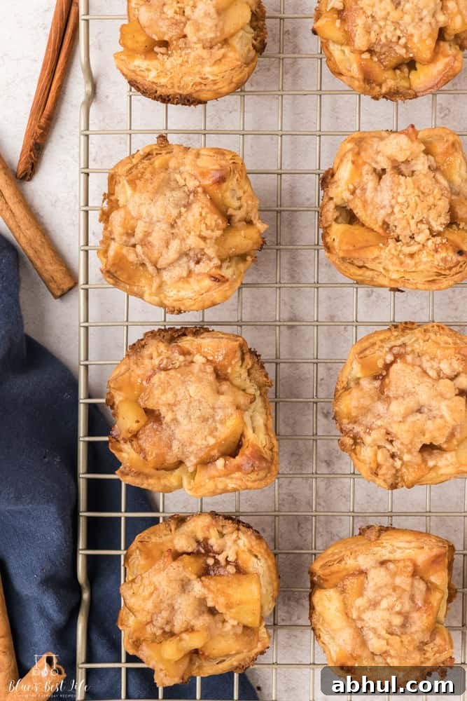 Mini Apple Pie Bites with Flaky Puff Pastry 2 Mini apple pie bites cooling on a wire rack.