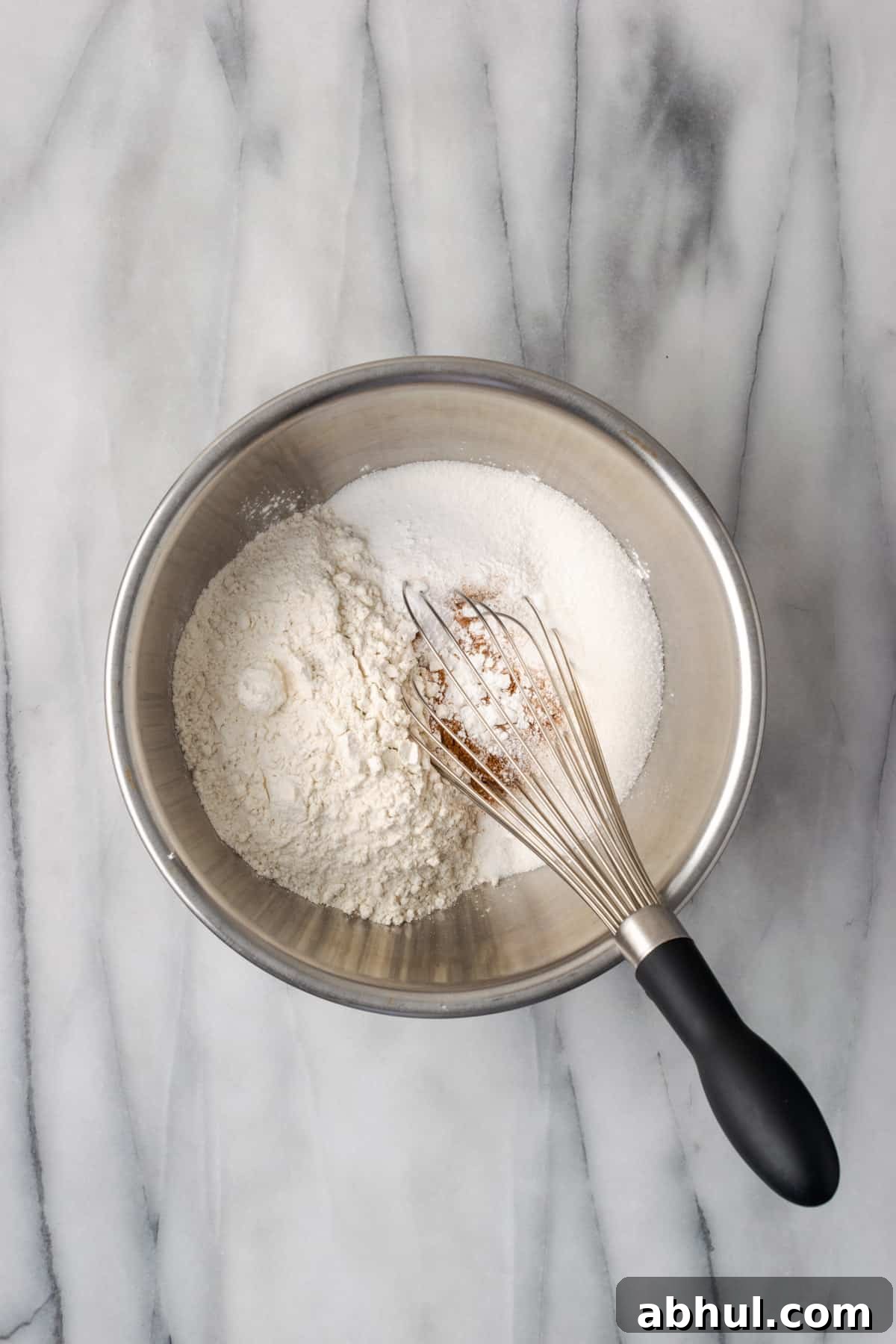 Gluten free flour, salt, baking powder, baking soda, cinnamon and sugar in a large metal mixing bowl.