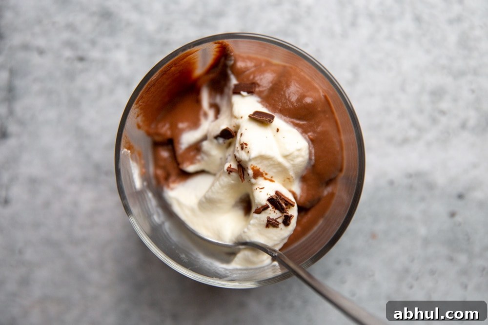 Homemade Gluten-Free Vanilla Pudding Recipe from Scratch 10 Half eaten bowl of homemade chocolate pudding with a spoon.