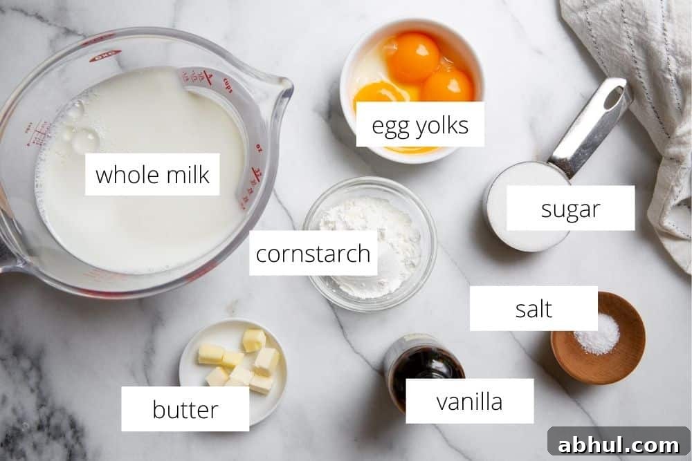 Homemade Gluten-Free Vanilla Pudding Recipe from Scratch 4 All of the ingredients for the homemade vanilla pudding recipe arranged on a marble surface with labels.