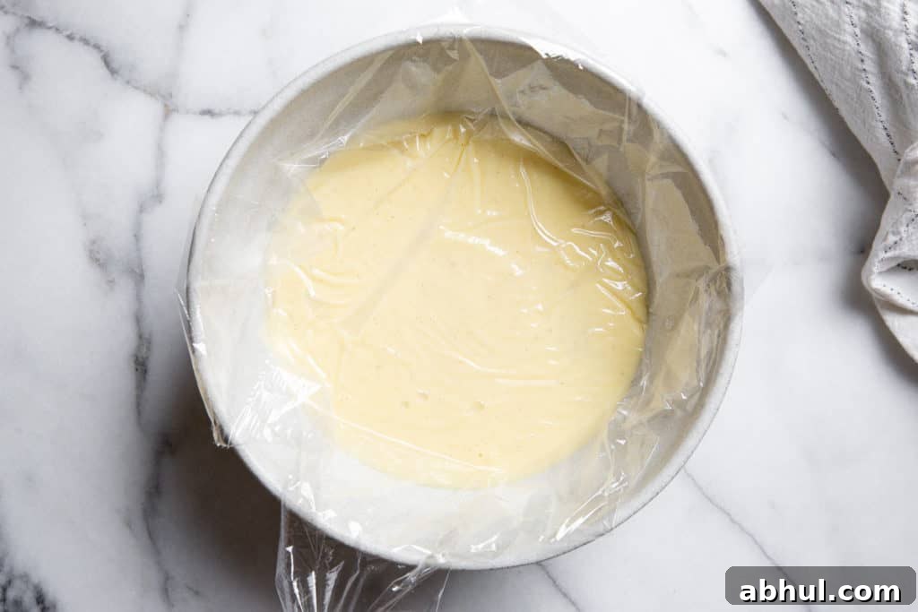 Homemade Gluten-Free Vanilla Pudding Recipe from Scratch 7 The homemade vanilla pudding in a bowl covered with plastic wrap.