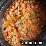 Slow Cooker Pork Ragu: Tender Slow-Braised Pork Ragù Recipe 12 Slow cooker pork ragu in a black crock pot.