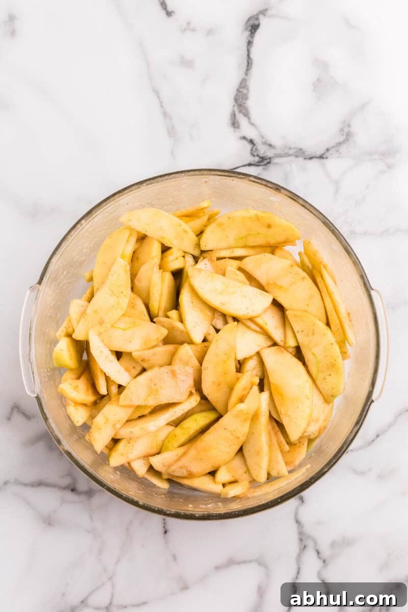 sliced apples tossed in the seasoning to make the apple filling.