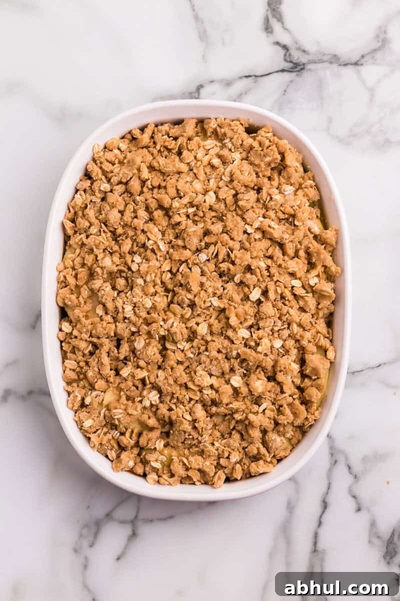 apple crisp in white baking dish.