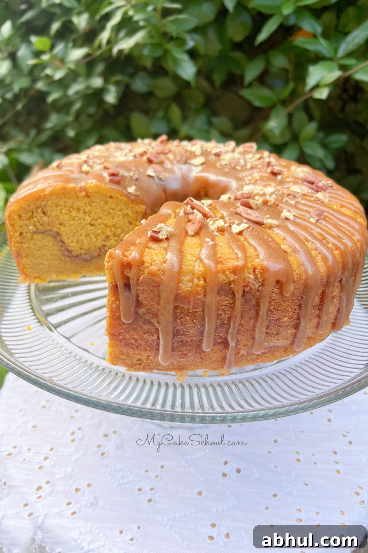 Pumpkin Snickerdoodle Bundt Cake, sliced, on a pedestal.