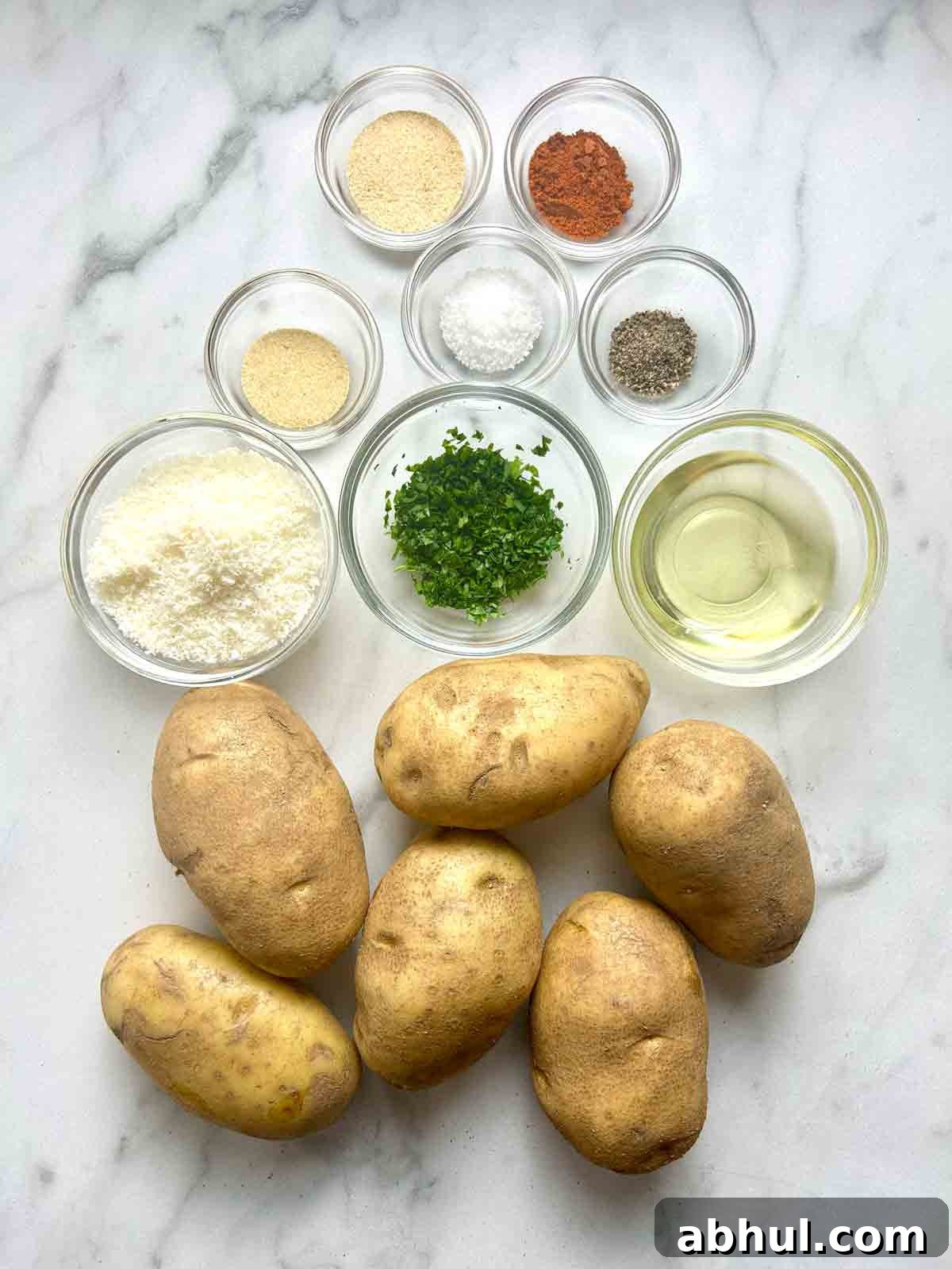 ingredients prepped in bowls; 6 whole Russet potatoes.
