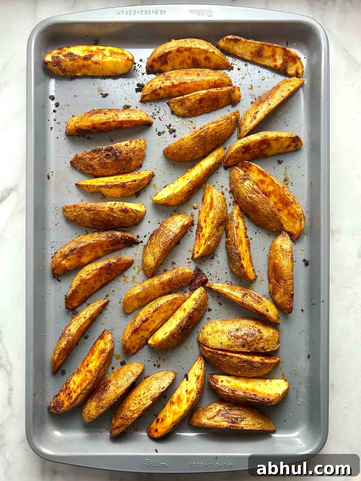 potato wedges on baking sheet after baking.