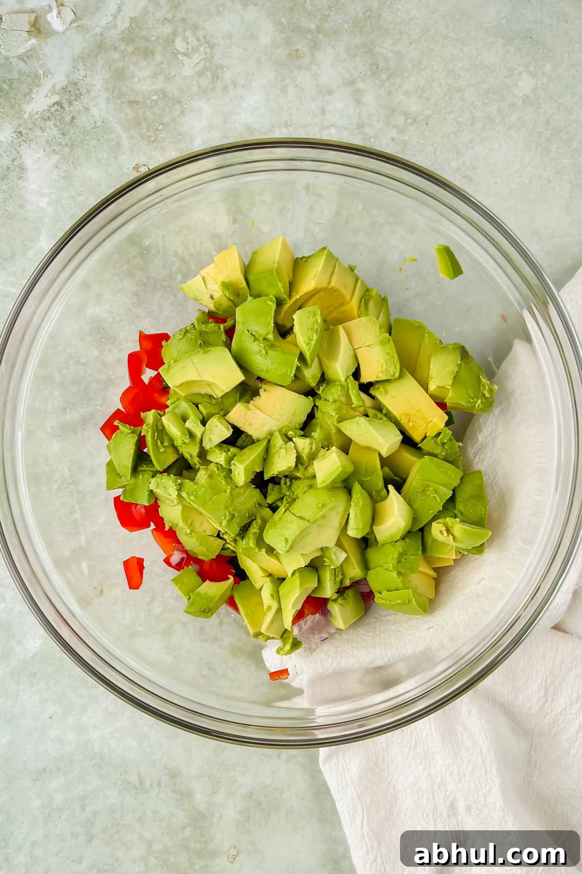 diced vegetables added to a mixing bowl.