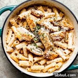 Creamy chicken bacon pasta in a skillet.