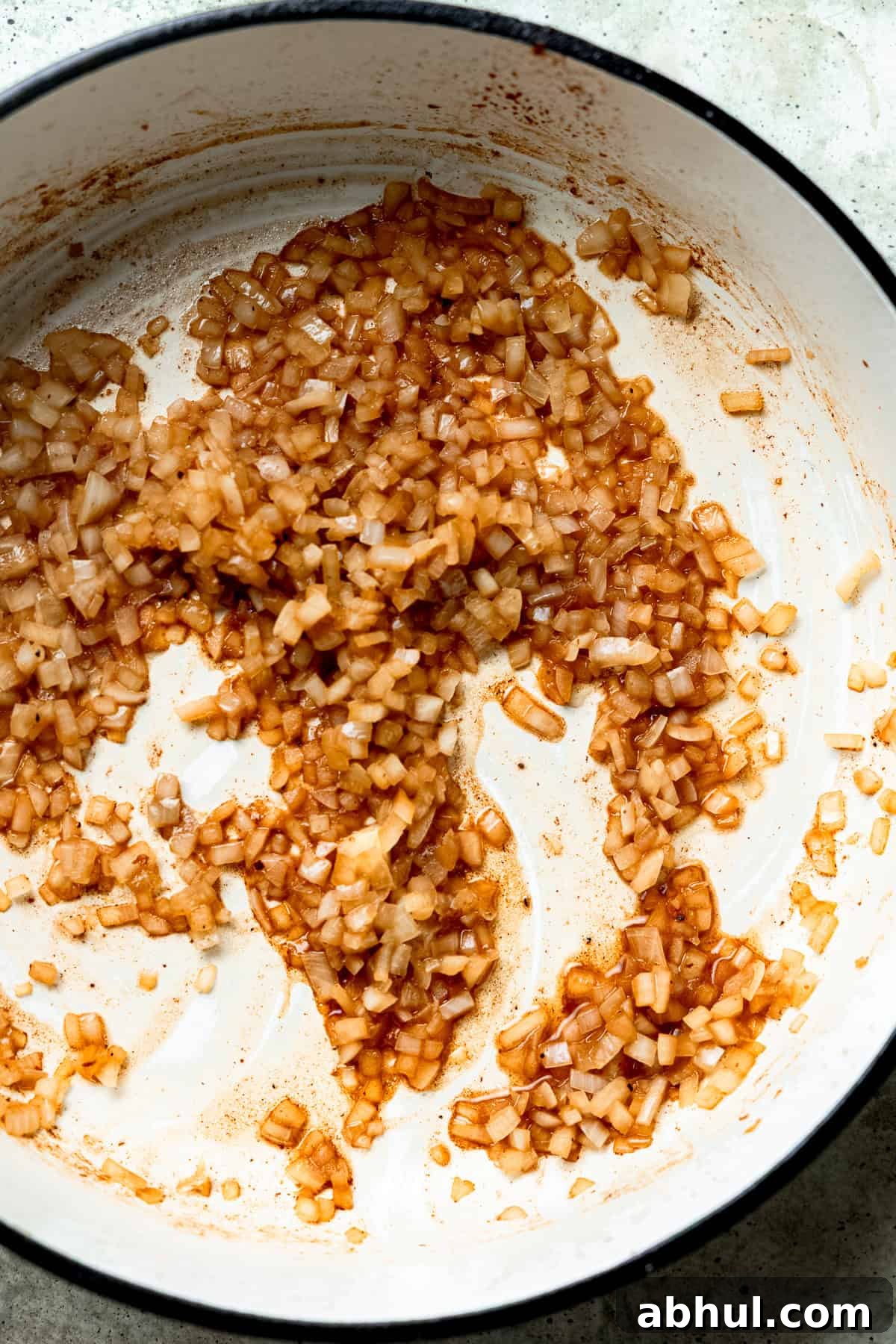 Onions and garlic being cooked until soft and fragrant.
