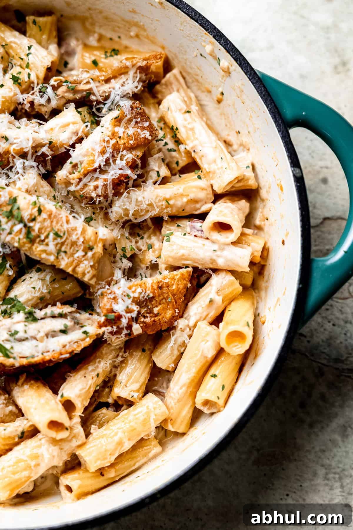 Close up of creamy chicken and bacon pasta in a skillet.