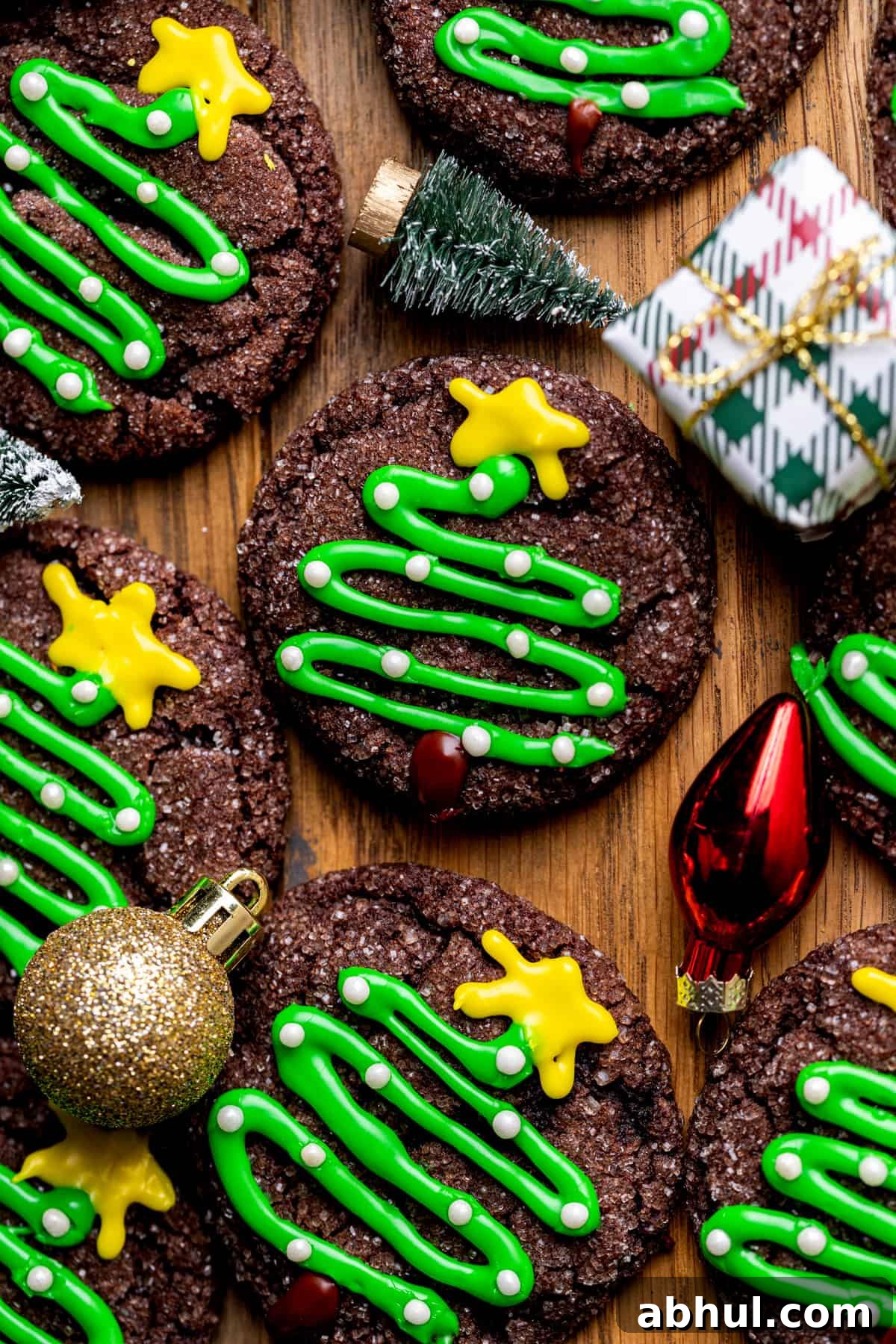 Christmas tree cookies with Christmas decoratations around it.