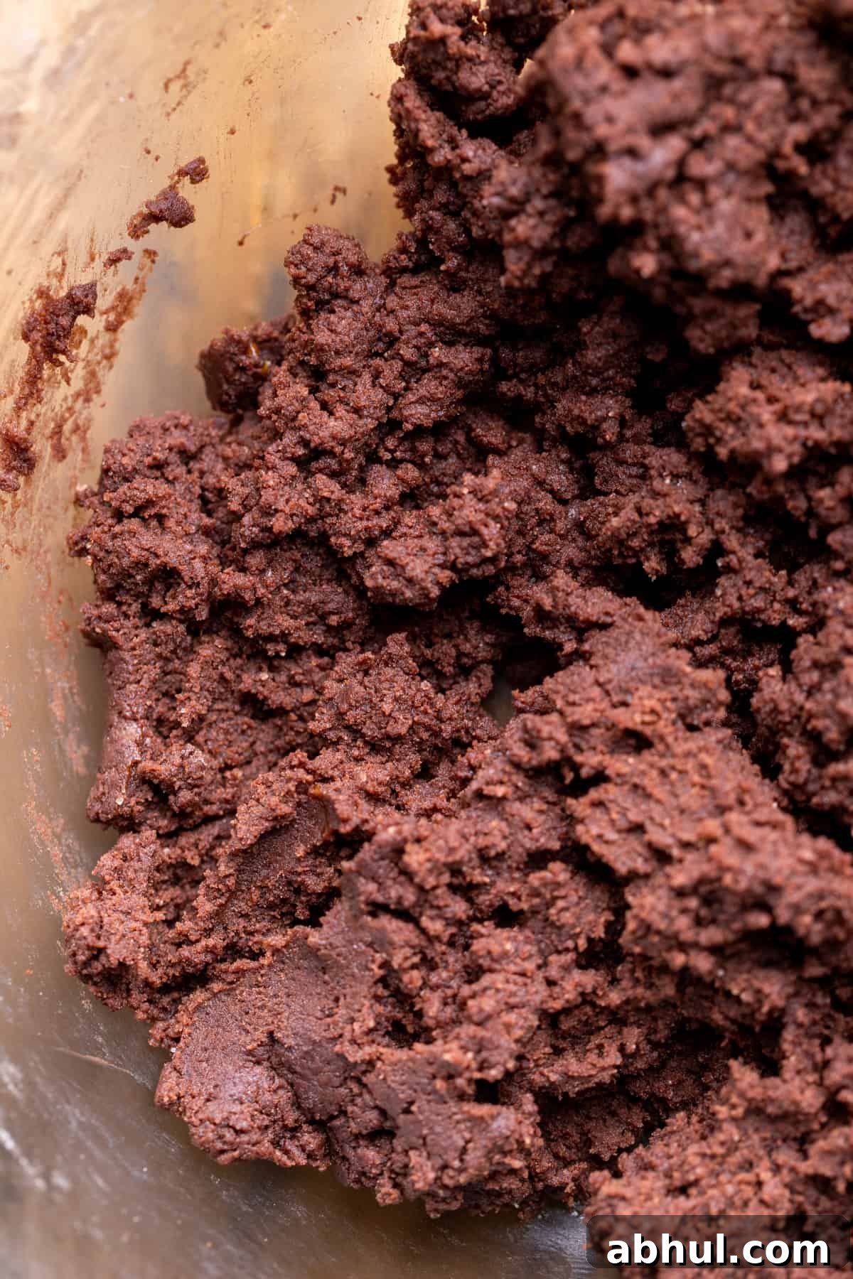 Chocolate cookie dough in a glass bowl.