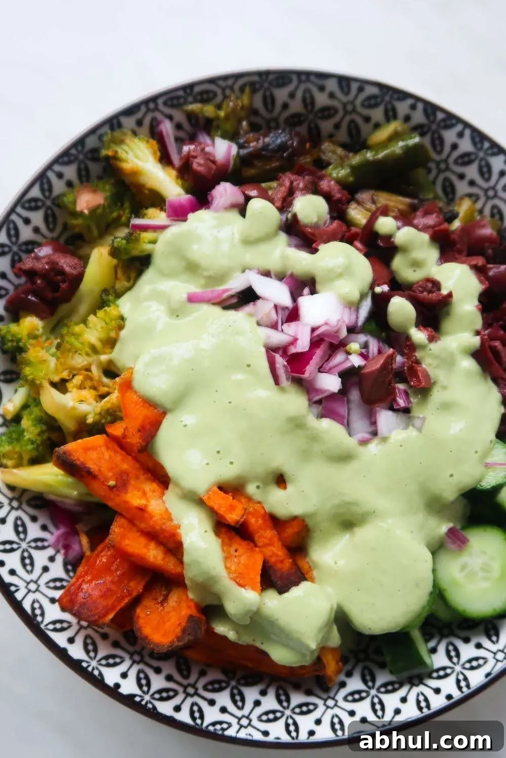 Roasted broccoli, sweet potatoes, asparagus and peppers make it into this healthy roasted vegetable salad! Drizzled with spicy creamy cashew sauce this roast vegetable salad recipe is dairy-free, gluten-free and vegan. It's perfect for vegan lunch or as a vegetable side dish!