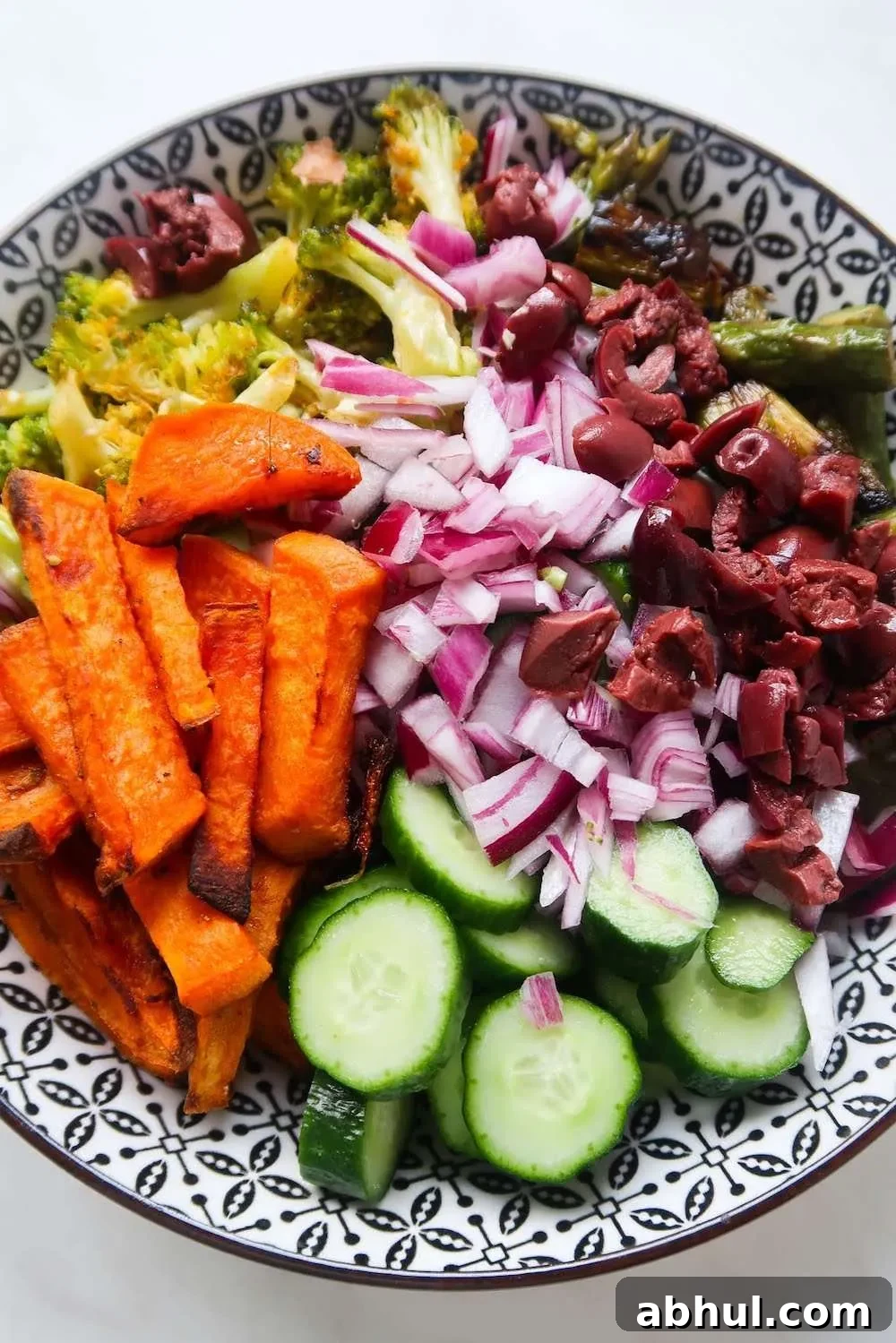 Roasted broccoli, sweet potatoes, asparagus and peppers make it into this healthy roasted vegetable salad! Drizzled with spicy creamy cashew sauce this roast vegetable salad recipe is dairy-free, gluten-free and vegan. It's perfect for vegan lunch or as a vegetable side dish!