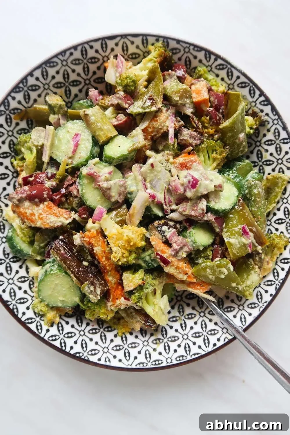 Roasted broccoli, sweet potatoes, asparagus and peppers make it into this healthy roasted vegetable salad! Drizzled with spicy creamy cashew sauce this roast vegetable salad recipe is dairy-free, gluten-free and vegan. It's perfect for vegan lunch or as a vegetable side dish!