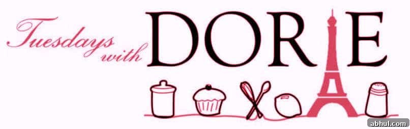 Tuesdays with Dorie logo in black and pink lettering with a cupcake, spoons, lemon, Eiffel tower and more