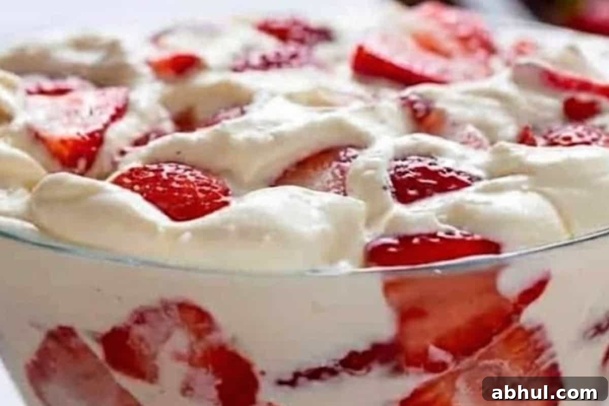  Lightly fold the sliced strawberries and desiccated coconut into the cheesecake mixture