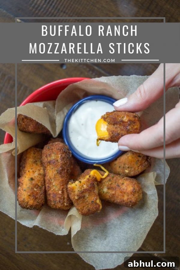 Buffalo Ranch Mozzarella Sticks | This twist on classic mozzarella sticks is so simple, Buffalo Ranch Mozzarella Sticks add spicy buffalo sauce and ranch seasoning for a spicy cheesy treat!