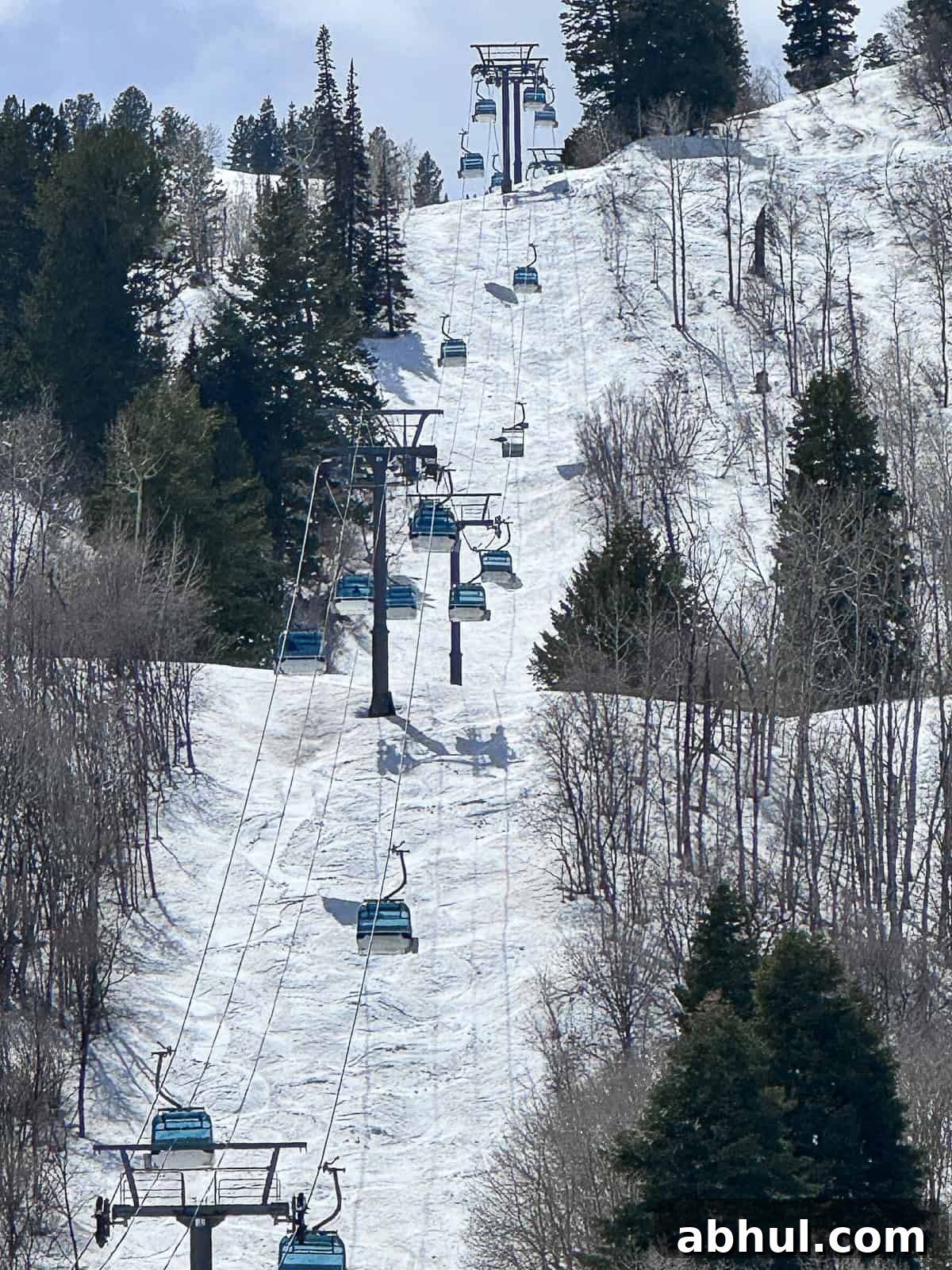 Jenna Passaro travel blogger outside Snowbasin Ski Resort gondola over slopes in Ogden Utah during April ski season