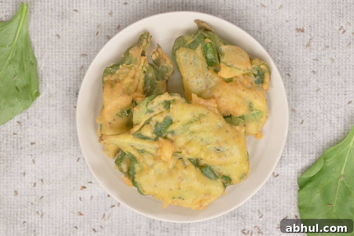 Fried spinach leaves arranged on a plate.