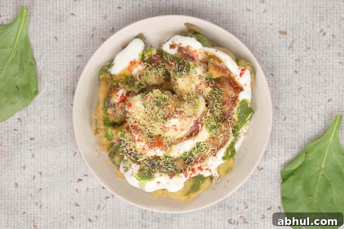 Ready palak patta chaat topped with spices and fine sev.