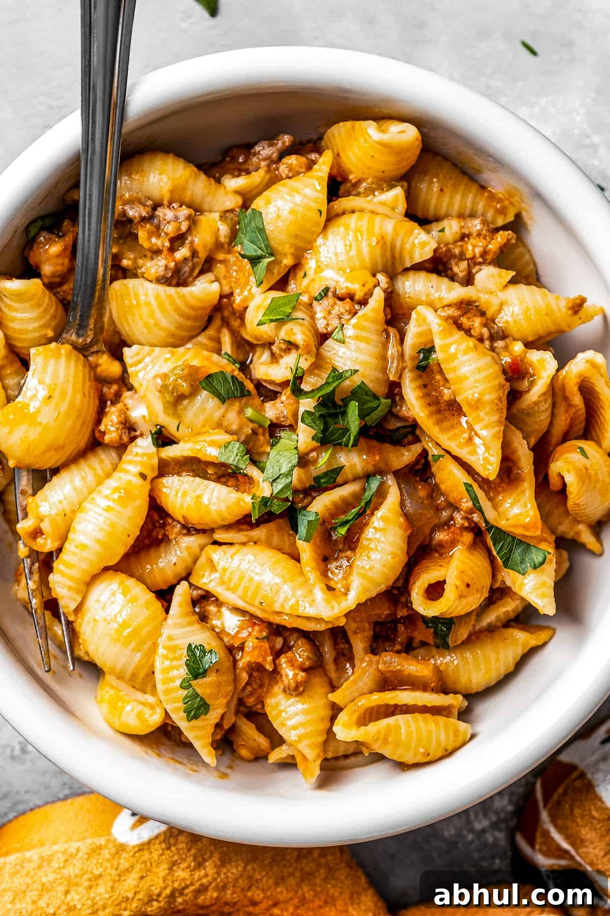 Overhead shot of taco pasta in a bowl with a fork.