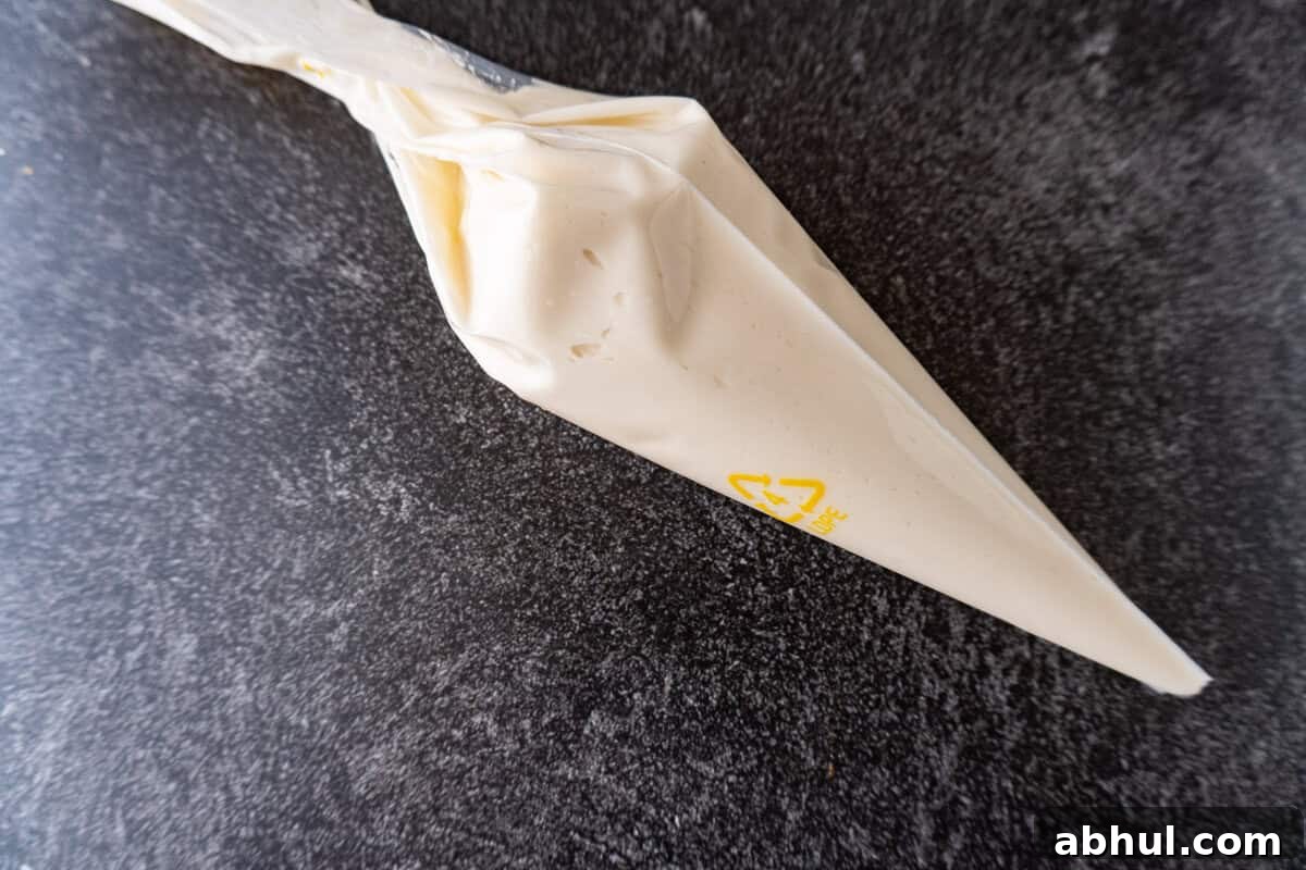 vanilla frosting filling in a piping bag.