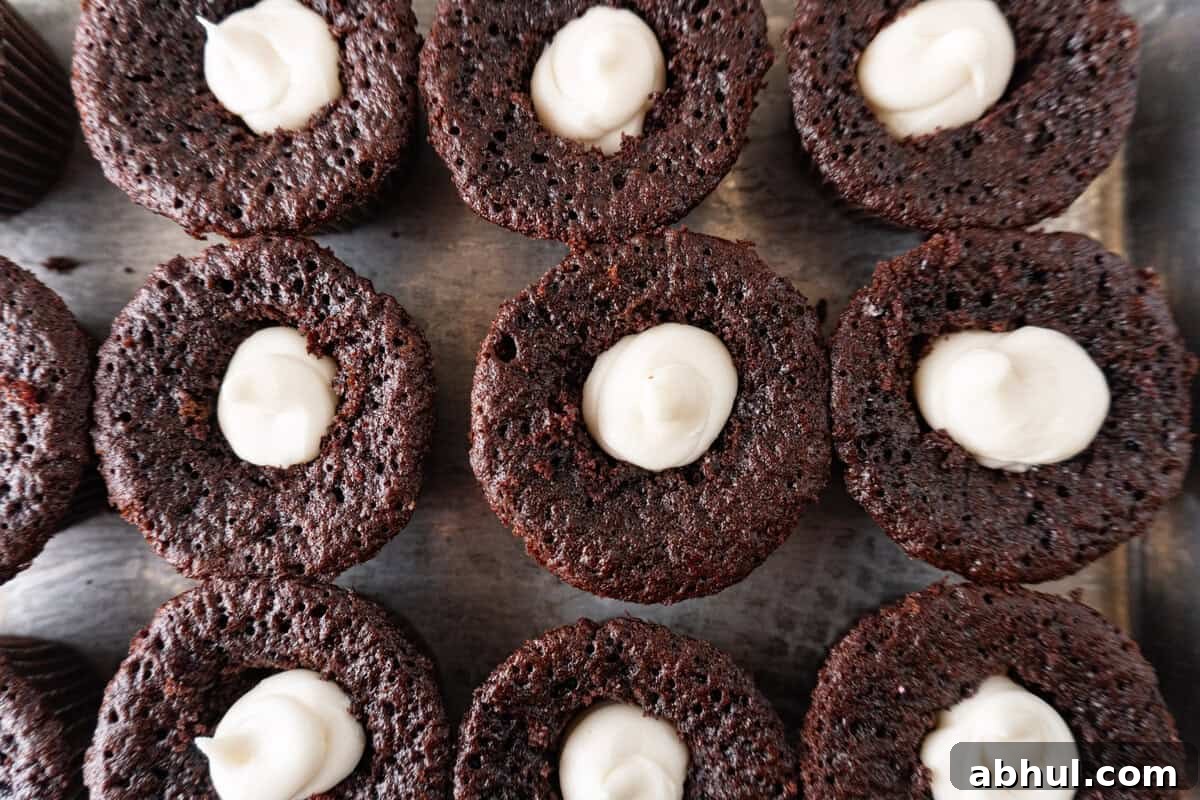cupcakes with filling piped into centers.