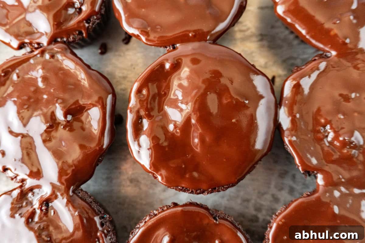 cupcakes with ganache spread on top.