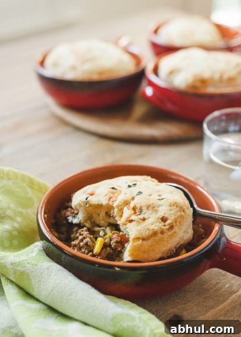 Buttermilk-Gruyere Biscuit Topped Shepherd's Pie in a small handled dish.