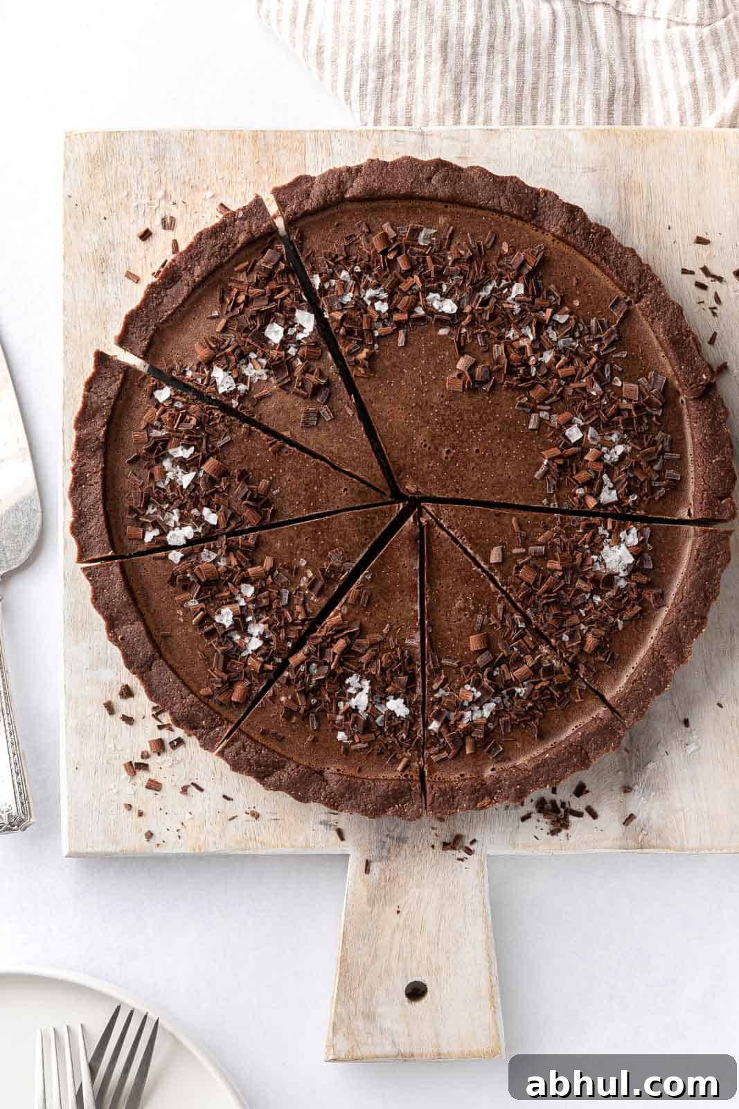 Sliced of vegan chocolate pie on a board.