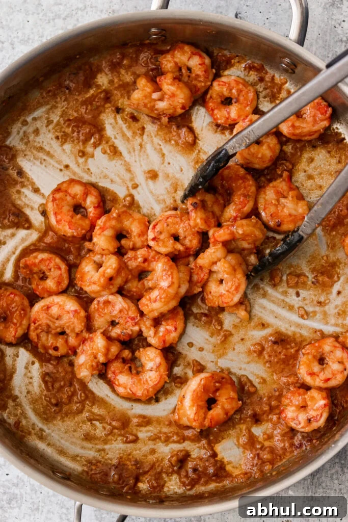 Stir frying shrimp with sauce in a pan
